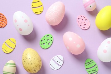 Happy Easter card. Easter eggs and decoration on color background, top view