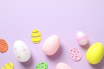 Happy Easter card. Easter eggs and decoration on color background, top view