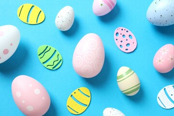 Happy Easter card. Easter eggs and decoration on color background, top view