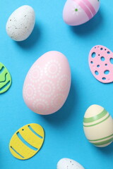 Happy Easter card. Easter eggs and decoration on color background, top view