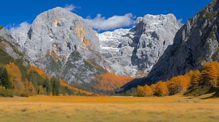 Obraz premium Autumnal Mountain Landscape with Snowcapped Peaks