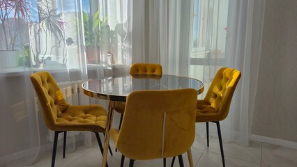 Marble table and yellow chairs in the interior