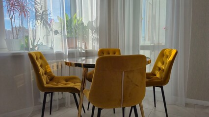 Marble table and yellow chairs in the interior
