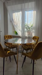 Marble table and yellow chairs in the interior