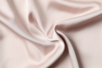 Beige silk satin. Shiny smooth fabric. Soft folds. Luxury background with space for design. Flat table, top view