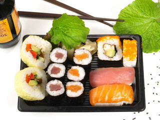 Box with different Sushi and Wasabi on white Background