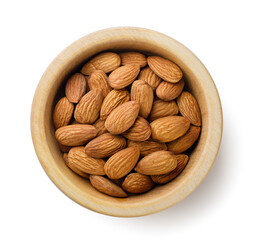 Almond nuts in a wooden plate on a white background. Top view