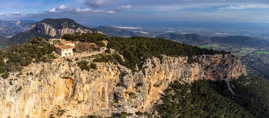 Fototapeta premium aerial view of the hermitage and Alaró Castle hostelry , Alaró hill, Dry stone route, Natural area of the Serra de Tramuntana., Majorca, Balearic Islands, Spain