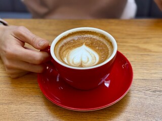 Red cappuccino cup with latte art