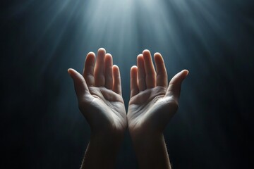Two hands extend gracefully from the bottom of the frame, reaching upward as beams of light emerge from above, illuminating their palms amidst a shadowy backdrop. This moment captures a sense of hope