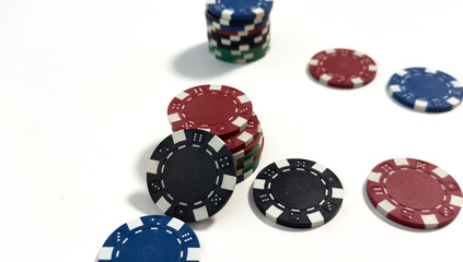 Plastic casino chips stacked on white background. Poker game