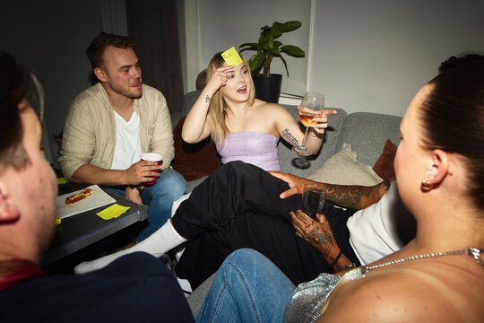 Friends playing guessing game during party at home