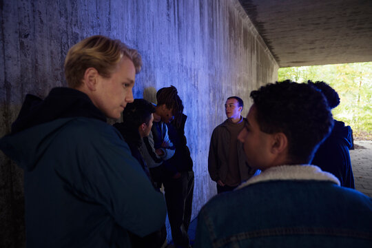Multiracial friends spending leisure time against textured wall