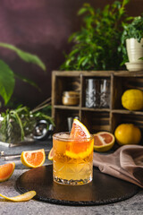 Refreshing cocktail with grapefruit slice and ice cubes on bar counter