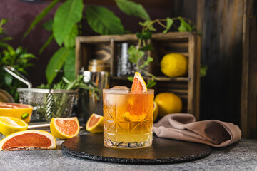 Refreshing paloma cocktail with grapefruit and ice on slate