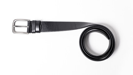 Black leather belt with matte metal buckle close-up isolated on white background. Fashionable everyday unisex accessory for jeans. Stylish mens or womens strap. Haberdashery goods. Empty text space.