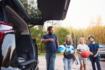 Father and happy kids spending leisure time in forest