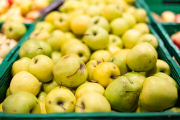Close-up of organic farm apples in the market for sale in crates.