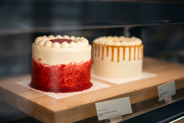 Red velvet cake on display in a pastry shop window.