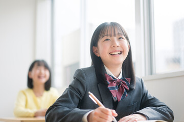 授業を受ける制服を着た女子中学生。
