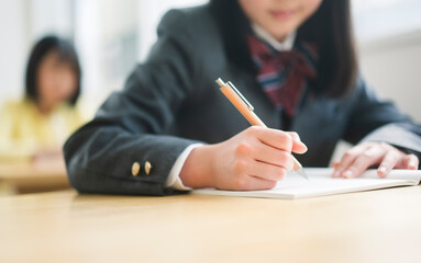 授業を受ける制服を着た女子中学生。