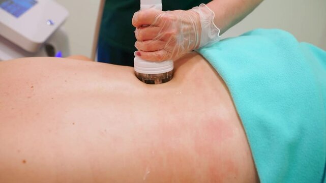 RF massage. Hardware cosmetology. Young woman getting rf lifting procedure in a beauty parlour.