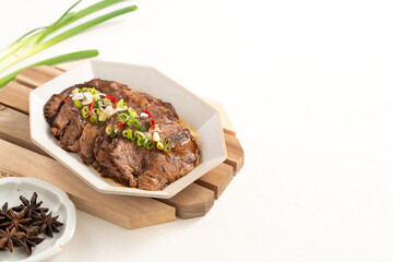 Taiwanese braised beef shank slices in a plate on white table background.