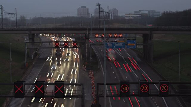 A high-speed timelapse of dense traffic on the R1 Ring Road in Antwerp, Belgium, transitioning from evening to night