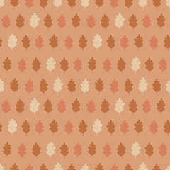 Autumn seamless pattern with silhouettes of oak leaves, a simple fall pattern in orange peachy brown palette
