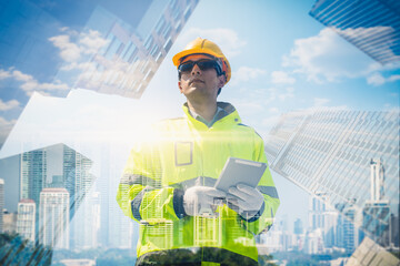 The double exposure image of the engineer thinking overlays with cityscape image with copy space. The concept of engineering, construction, futuristic and industry..
