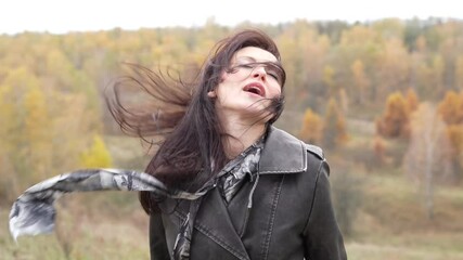 Central park in New York. Girl in fall trench. Autumn landscape with gothic woman has windy hair. Stylish woman sing in autumn landscape outdoor. Fall nature landscape and girl. Pensive woman - Powered by Adobe