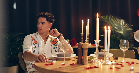 Man, thinking and waiting for date, romance and late for dinner in restaurant and valentines day. Night, worried and person with reservation for anniversary, fine dining and decor for celebration