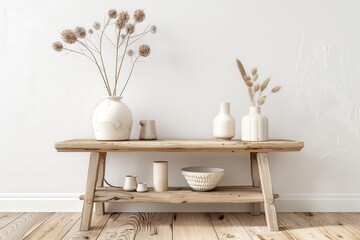 Rustic wooden bench with white vases. dried flowers. and ceramic bowls. against a white wall and wooden floor