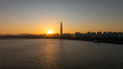 Naklejka premium Aerial view of Seoul, South Korea, with the Hangang River winding through the city, video by towering skyscrapers and historical landmarks 