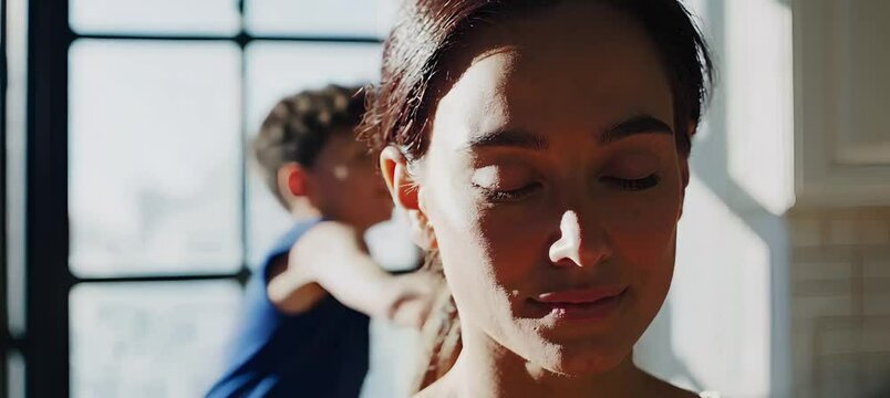 Mom finds peace and meditation amid joyful chaos in sunlit kitchen