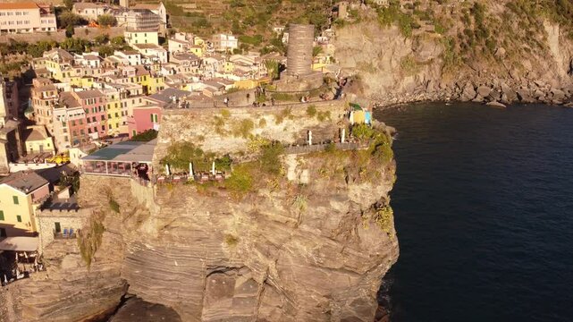 Ruins of Doria Tower on a hilltop overlooking ocean on a sunny day at Cinque Terre National Park
