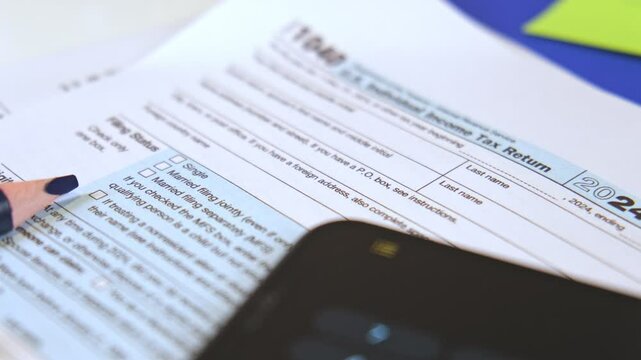 Accountant preparing tax form 1040 for tax season 2025