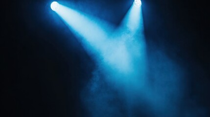 Two beams of blue spotlight shine through a smoky haze, creating a dramatic and captivating atmosphere.