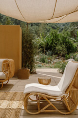 A charming outdoor boutique in Fethiye, Türkiye, surrounded by lush greenery and rustic decor. The shaded space features wooden furniture, natural textures, and a relaxed Mediterranean vibe