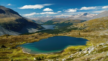 Naklejka premium Breathtaking mountain valley with clear blue lakes under a bright sky, featuring vibrant green grass and rocky terrain in a stunning natural landscape
