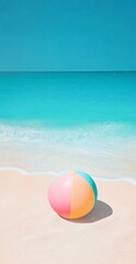 Obraz premium Vibrant Beach Ball on Sandy Shore by Turquoise Ocean with Bright Sky in Summer