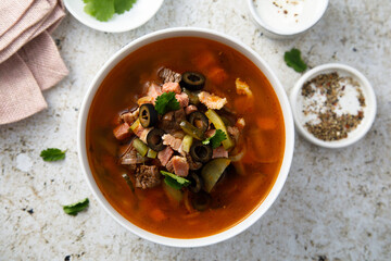 Meat soup with gherkins and olives