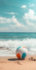 Obraz premium Colorful Beach Ball on Sandy Shore with Ocean Waves and Vibrant Blue Sky on a Sunny Day