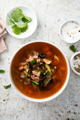 Meat soup with gherkins and olives