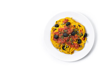 Italian Pasta puttanesca with tomato sauce, capers, and black olives isolated on white background. Top view. Copy space