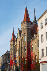Historic building with spires and fountain in a town square during autumn in Walbrzych, Poland