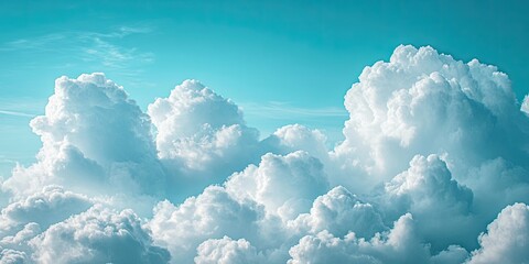 Fluffy white clouds densely packed in the upper third, contrasting gently with a vibrant blue sky in the background, creating a serene atmosphere.