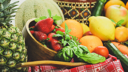 rustic composition of mixed fruits and vegetables viewed from above