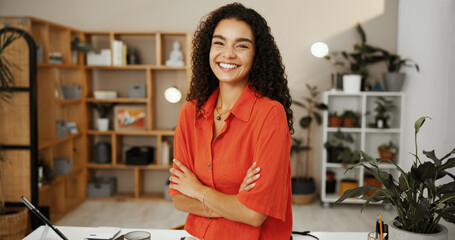 Small business, portrait and woman with arms crossed, confident and smile for sales in flower shop. Office, entrepreneur and person with pot plants for online store, retail and happy with stock