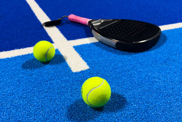 Paddle racket with a ball. Padel court 